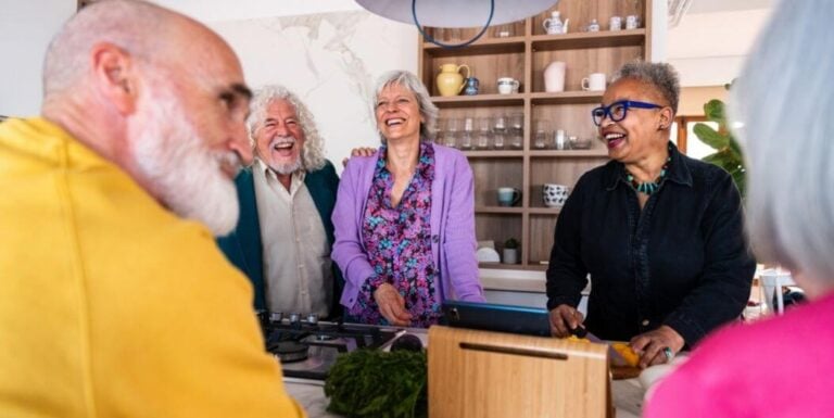 Group of Seniors Socializing in Kitchen at Independent Living Facility